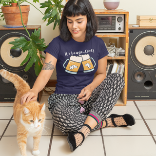 Beagle-Thirty Mugs Unisex Jersey Short Sleeve Tee in Navy. The front of shirt showcases Two Dog Adorned Mugs clinking with the saying, "It's Beagle-Thirty" above it.  Back of shirt features corresponding Benefit Beagle Logo.