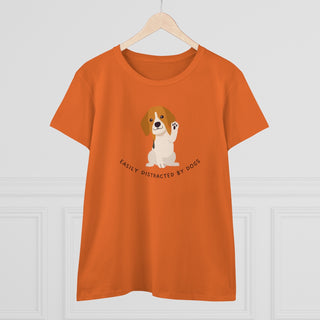 Easily Distracted Women's Midweight Cotton Tee in Orange. Shown is front design featuring a dog waving with the saying "Easily Distracted by Dogs" below it. The back of shirt has the classic Benefit Beagle Logo