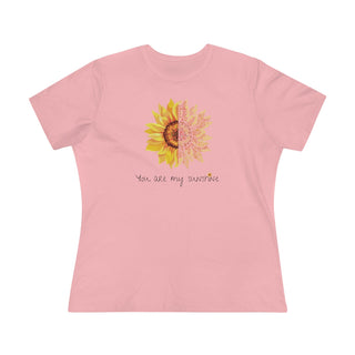 You are my Sunshine Women's Premium Tee shirt in Pink. Shown is the front showcasing a sunflower which is split down the middle and half is made out of paw prints. Underneath is the phrase "You are my Sunshine" . Back of shirt features the Sunflower Benefit Beagle Logo.