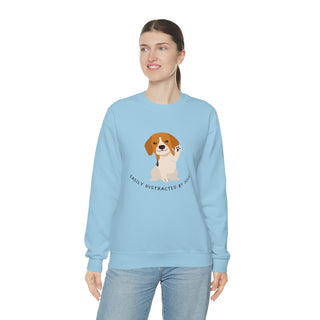 Easily Distracted Unisex Heavy Blend Crewneck Sweatshirt in Light Blue. Shown is front design featuring a dog waving with the saying "Easily Distracted by Dogs" below it. The back of shirt has the classic Benefit Beagle Logo.