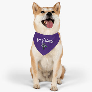 Dog wearing the Signature Tattoo Flower Dog Collar Bandana in Purple. The Signature Tattoo Flower design features the word "beagletude" with a tattoo style flower under it. Comes with adjustable black collar.