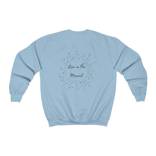 Live in the Moment Crewneck Sweatshirt in Light Blue. The Live in the Moment design features a graphic on the back with the phrase "Live in the Moment" surrounded by shooting stars.