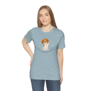 Easily Distracted Unisex Jersey Short Sleeve Tee in Light Blue. Shown is front design featuring a dog waving with the saying "Easily Distracted by Dogs" below it. The back of shirt has the classic Benefit Beagle Logo.