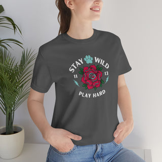 Stay Wild Unisex Premium Tee in Asphalt. Shown is front of Stay Wild Design features a tattoo style rose with the phrase "Stay Wild, Play Hard" around it. The back of shirt features the Stay Wild Benefit Beagle Logo Design.