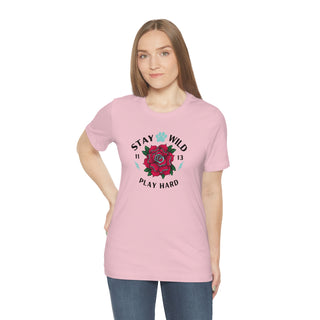 Stay Wild Unisex Premium Tee in Pink. Shown is front of Stay Wild Design features a tattoo style rose with the phrase "Stay Wild, Play Hard" around it. The back of shirt features the Stay Wild Benefit Beagle Logo Design.