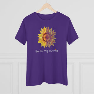 You are my Sunshine Women's Premium Tee shirt in Purple. Shown is the front showcasing a sunflower which is split down the middle and half is made out of paw prints. Underneath is the phrase "You are my Sunshine" . Back of shirt features the Sunflower Benefit Beagle Logo.