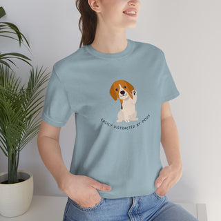 Easily Distracted Unisex Jersey Short Sleeve Tee in Light Blue. Shown is front design featuring a dog waving with the saying "Easily Distracted by Dogs" below it. The back of shirt has the classic Benefit Beagle Logo.