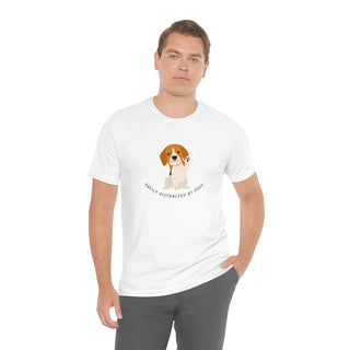 Easily Distracted Unisex Jersey Short Sleeve Tee in White. Shown is front design featuring a dog waving with the saying "Easily Distracted by Dogs" below it. The back of shirt has the classic Benefit Beagle Logo.