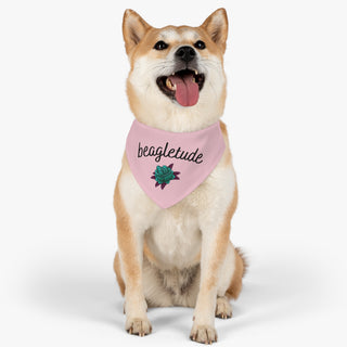 Dog wearing the Signature Tattoo Roses Dog Collar Bandana in Pink. The Signature Tattoo Roses design features the word "beagletude" with a tattoo style rose under it. Comes with adjustable black collar.