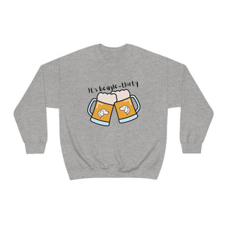 Beagle-Thirty Mugs Unisex Heavy Blend Crewneck Sweatshirt in Sport Grey. The front of shirt showcases Two Dog Adorned Mugs clinking with the saying, "It's Beagle-Thirty" above it. Back of shirt features corresponding Benefit Beagle Logo.