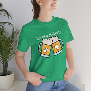 Beagle-Thirty Mugs Unisex Jersey Short Sleeve Tee in Heather Kelly. The front of shirt showcases Two Dog Adorned Mugs clinking with the saying, "It's Beagle-Thirty" above it. Back of shirt features corresponding Benefit Beagle Logo.