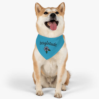 Dog wearing the Signature Tattoo Flower Dog Collar Bandana in Blue. The Signature Tattoo Flower design features the word "beagletude" with a tattoo style flower under it. Comes with adjustable black collar.