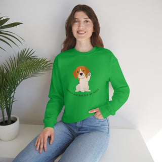 Easily Distracted Unisex Heavy Blend Crewneck Sweatshirt in Kelly Green. Shown is front design featuring a dog waving with the saying "Easily Distracted by Dogs" below it. The back of shirt has the classic Benefit Beagle Logo.