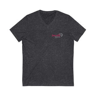 Different Pawspective Unisex V-Neck Tee in Deep Grey Heather. Shown is front of shirt with Benefit Beagle logo in the top corner . On the back is large colorful pawprint with the the phrase "Life is all about finding the beauty in a different pawspective" circled around it.