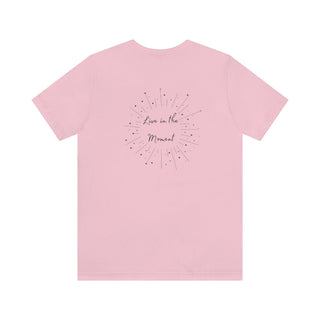 Live in the Moment Unisex Short Sleeve Tee in Pink. The Live in the Moment design features a graphic on the back with the phrase "Live in the Moment" surrounded by shooting stars.