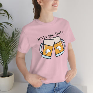 Beagle-Thirty Mugs Unisex Jersey Short Sleeve Tee in Pink. The front of shirt showcases Two Dog Adorned Mugs clinking with the saying, "It's Beagle-Thirty" above it. Back of shirt features corresponding Benefit Beagle Logo.