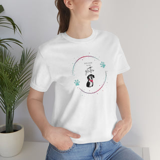 Dog Hair is my Glitter Unisex Jersey Short Sleeve Tee in White. The Dog Hair is my Glitter design features a dog with the phrase "Dog Hair is my Glitter" above it and it is surrounded by a circle with paw prints.