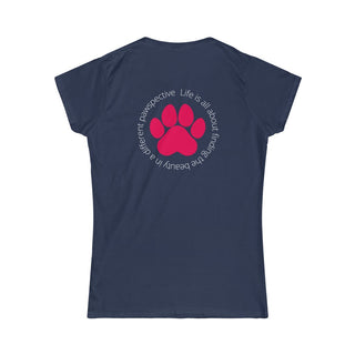 Different Pawspective Women's Softstyle Tee in Navy. Shown is the back of shirt featuring a large colorful pawprint with the the phrase "Life is all about finding the beauty in a different pawspective" circled around it. The Benefit Beagle Logo is located in the top corner on the front of shirt.