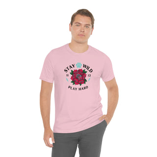 Stay Wild Unisex Premium Tee in Pink. Shown is front of Stay Wild Design features a tattoo style rose with the phrase "Stay Wild, Play Hard" around it. The back of shirt features the Stay Wild Benefit Beagle Logo Design.