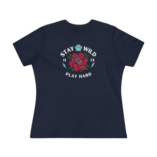 Stay Wild Women's Premium Tee in Navy. Shown is front of Stay Wild Design features a tattoo style rose with the phrase "Stay Wild, Play Hard" around it. The back of shirt features the Stay Wild Benefit Beagle Logo Design.  