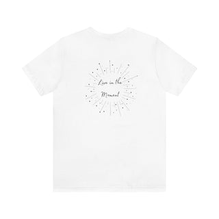 Live in the Moment Unisex Short Sleeve Tee in White. The Live in the Moment design features a graphic on the back with the phrase "Live in the Moment" surrounded by shooting stars.