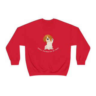 Easily Distracted Unisex Heavy Blend Crewneck Sweatshirt in Red. Shown is front design featuring a dog waving with the saying "Easily Distracted by Dogs" below it. The back of shirt has the classic Benefit Beagle Logo.