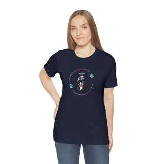 Dog Hair is my Glitter Unisex Jersey Short Sleeve Tee in Navy. The Dog Hair is my Glitter design features a dog with the phrase "Dog Hair is my Glitter" above it and it is surrounded by a circle with paw prints.