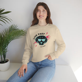 Play Hard Unisex Heavy Blend Crewneck Sweatshirt in Sand. The design features a cool dog with sunglasses and lightening bolts around it. The phrase "Live Fast, Play Hard" is around the design.