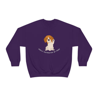 Easily Distracted Unisex Heavy Blend Crewneck Sweatshirt in Purple. Shown is front design featuring a dog waving with the saying "Easily Distracted by Dogs" below it. The back of shirt has the classic Benefit Beagle Logo.