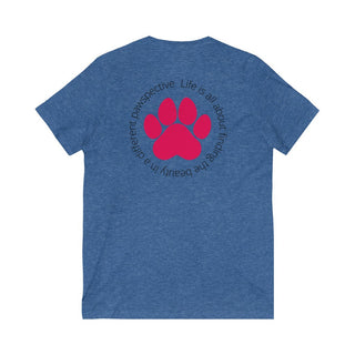 Different Pawspective Unisex V-Neck Tee in Heather True Blue. Shown is the back of shirt featuring a large colorful pawprint with the the phrase "Life is all about finding the beauty in a different pawspective" circled around it. The Benefit Beagle Logo is located in the top corner on the front of shirt.