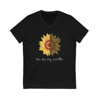 You are my Sunshine Unisex V-Neck Tee in Black. Shown is the front showcasing a sunflower which is split down the middle and half is made out of paw prints. Underneath is the phrase "You are my Sunshine" . Back of shirt features the Sunflower Benefit Beagle Logo.