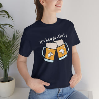 Beagle-Thirty Mugs Unisex Jersey Short Sleeve Tee in Navy. The front of shirt showcases Two Dog Adorned Mugs clinking with the saying, "It's Beagle-Thirty" above it. Back of shirt features corresponding Benefit Beagle Logo.