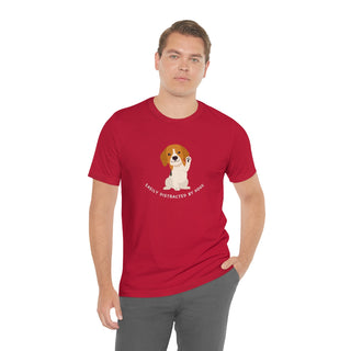 Easily Distracted Unisex Jersey Short Sleeve Tee in Red. Shown is front design featuring a dog waving with the saying "Easily Distracted by Dogs" below it. The back of shirt has the classic Benefit Beagle Logo.