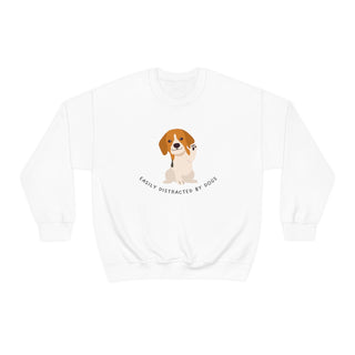 Easily Distracted Unisex Heavy Blend Crewneck Sweatshirt in White. Shown is front design featuring a dog waving with the saying "Easily Distracted by Dogs" below it. The back of shirt has the classic Benefit Beagle Logo.