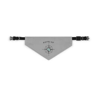 Grey dog collar bandana with the Adventures Await design features a nautical compass with the profile of a dog in the center. Comes with adjustable black collar. 