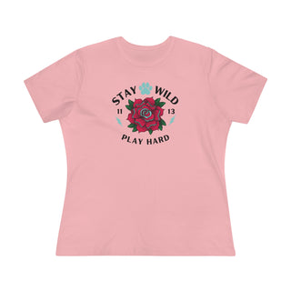 Stay Wild Women's Premium Tee in Pink. Shown is front of Stay Wild Design features a tattoo style rose with the phrase "Stay Wild, Play Hard" around it. The back of shirt features the Stay Wild Benefit Beagle Logo Design.