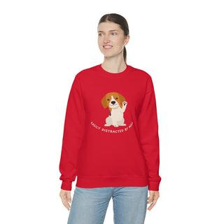 Easily Distracted Unisex Heavy Blend Crewneck Sweatshirt in Red. Shown is front design featuring a dog waving with the saying "Easily Distracted by Dogs" below it. The back of shirt has the classic Benefit Beagle Logo.