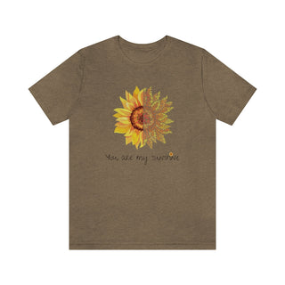 You are my Sunshine Unisex Jersey Short Sleeve Tee in Heather Olive. Shown is the front showcasing a sunflower which is split down the middle and half is made out of paw prints. Underneath is the phrase "You are my Sunshine" . Back of shirt features the Sunflower Benefit Beagle Logo.