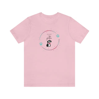 Dog Hair is my Glitter Unisex Jersey Short Sleeve Tee in pink. The Dog Hair is my Glitter design features a dog with the phrase "Dog Hair is my Glitter" above it and it is surrounded by a circle with paw prints.