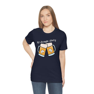 Beagle-Thirty Mugs Unisex Jersey Short Sleeve Tee in Navy. The front of shirt showcases Two Dog Adorned Mugs clinking with the saying, "It's Beagle-Thirty" above it. Back of shirt features corresponding Benefit Beagle Logo.