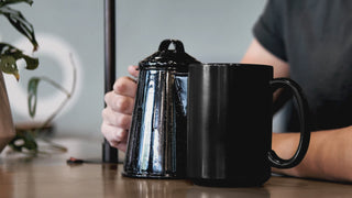 Video of color morphing mug with dogs holding roses in their mouths and the saying "I woof you too" showing the mug color morphing from dark to white with hot beverage. 