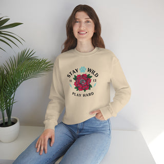 Stay Wild Unisex Heavy Blend Crewneck Sweatshirt in Sand. The Stay Wild Design features a tattoo style rose with the phrase "Stay Wild, Play Hard" around it. The back of shirt features the Stay Wild Benefit Beagle Logo Design.