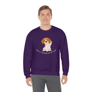 Easily Distracted Unisex Heavy Blend Crewneck Sweatshirt in Purple. Shown is front design featuring a dog waving with the saying "Easily Distracted by Dogs" below it. The back of shirt has the classic Benefit Beagle Logo.