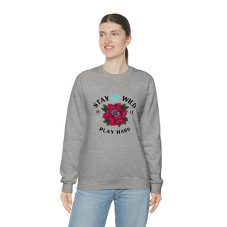 Stay Wild Unisex Heavy Blend Crewneck Sweatshirt in Sport Grey. The Stay Wild Design features a tattoo style rose with the phrase "Stay Wild, Play Hard" around it. The back of shirt features the Stay Wild Benefit Beagle Logo Design.