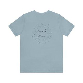 Live in the Moment Unisex Short Sleeve Tee in Light Blue. The Live in the Moment design features a graphic on the back with the phrase "Live in the Moment" surrounded by shooting stars.