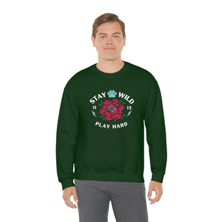 Stay Wild Unisex Heavy Blend Crewneck Sweatshirt in Forest Green. The Stay Wild Design features a tattoo style rose with the phrase "Stay Wild, Play Hard" around it. The back of shirt features the Stay Wild Benefit Beagle Logo Design.