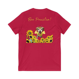 Bee Pawsitive Unisex V-neck Tee shirt in Red. Shown is back of shirt showcasing a dog dressed as as bee in a a field of sunflowers with the phrase "Bee Pawsitive!" above it. The front features the Bee Pawsitive Benefit Beagle Logo.