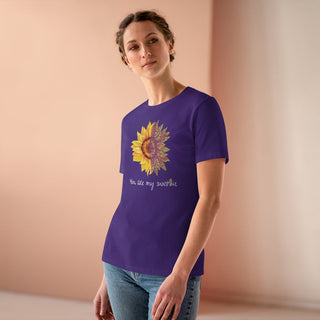 You are my Sunshine Women's Premium Tee shirt in Purple. Shown is the front showcasing a sunflower which is split down the middle and half is made out of paw prints. Underneath is the phrase "You are my Sunshine" . Back of shirt features the Sunflower Benefit Beagle Logo.