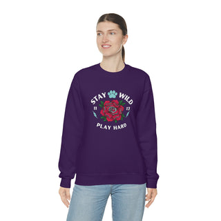 Stay Wild Unisex Heavy Blend Crewneck Sweatshirt in Purple. The Stay Wild Design features a tattoo style rose with the phrase "Stay Wild, Play Hard" around it. The back of shirt features the Stay Wild Benefit Beagle Logo Design.