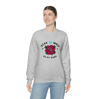 Stay Wild Unisex Heavy Blend Crewneck Sweatshirt in Ash. The Stay Wild Design features a tattoo style rose with the phrase "Stay Wild, Play Hard" around it. The back of shirt features the Stay Wild Benefit Beagle Logo Design.